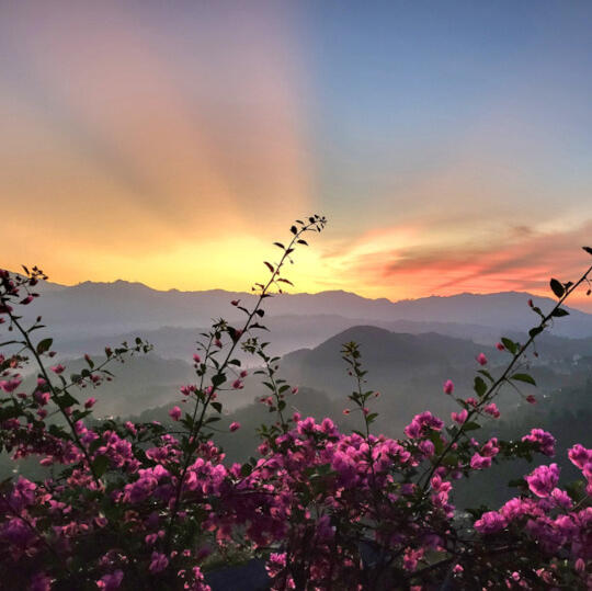 Image of sunrise behind mountains
